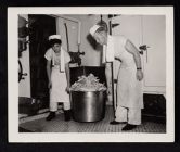 Shipboard Life. 2 cooks, with pot full of possibly celery 